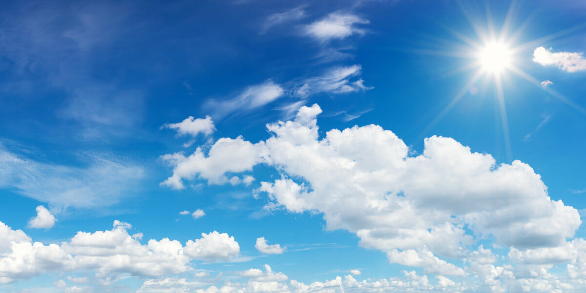blue sky with clouds and sun reflection.The sun shines bright in